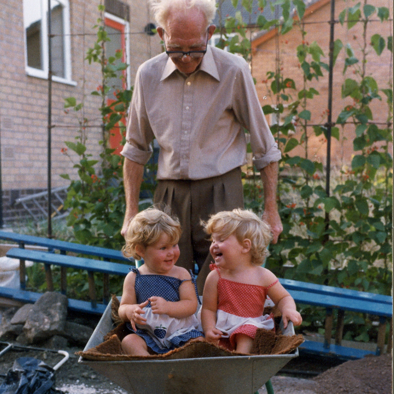 Baby photo of Frankie of Pink Photographics, Lincolnshire wedding Photographer and her twin sister sat in a wheelbarrow 