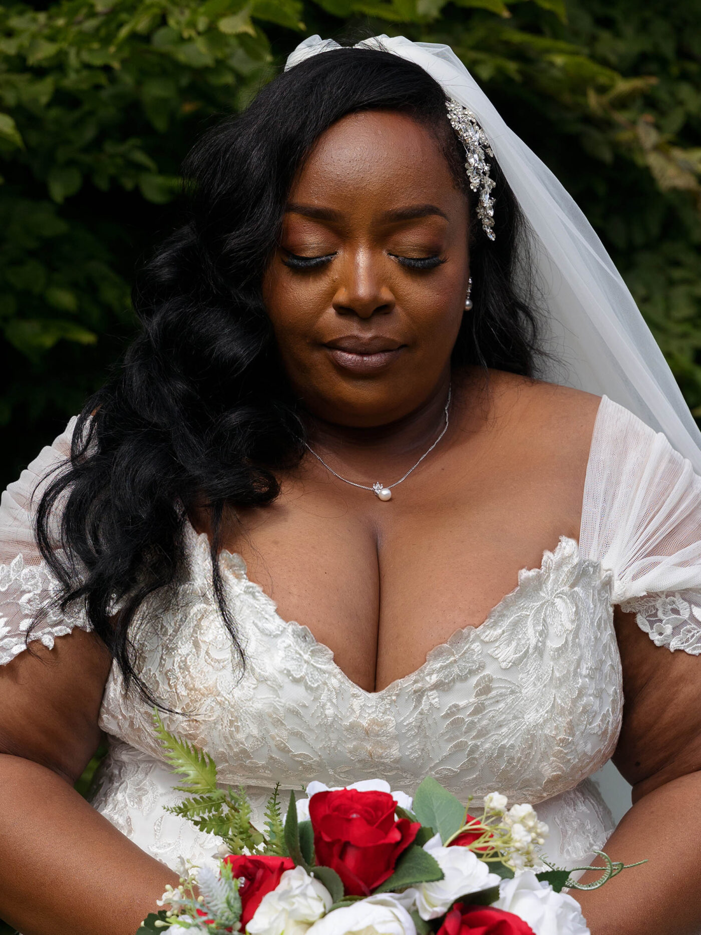 A Bride (POC) is taking a moment gently closing her eyes