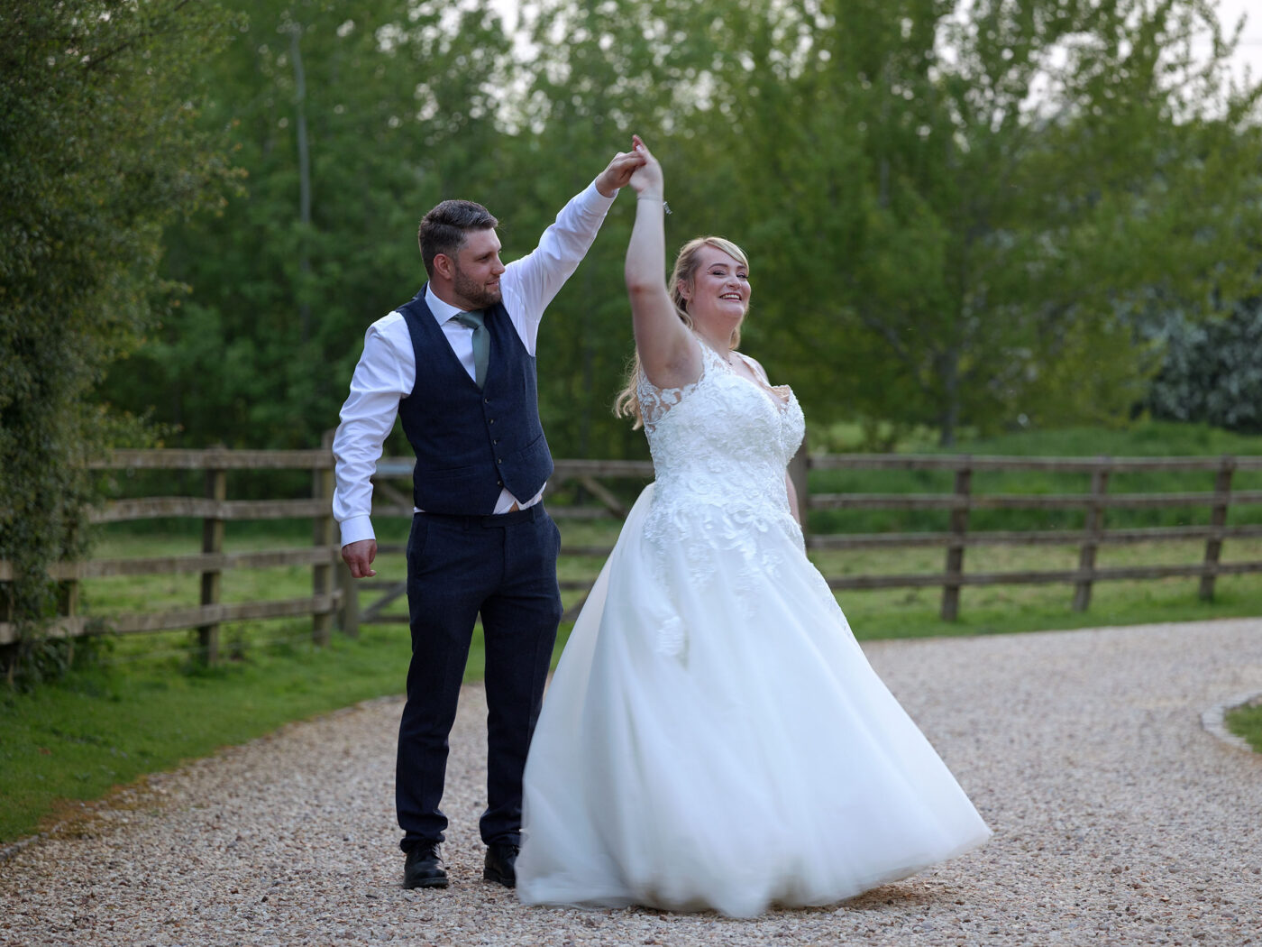 A Bride and Groom dance together outside at Barnsdale during Golden hour