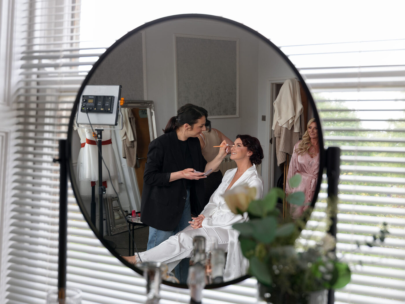 Reflections in a mirror in the Bridal Suite at Carr Bank. The Bride is having her make up done ahead of the cremony.