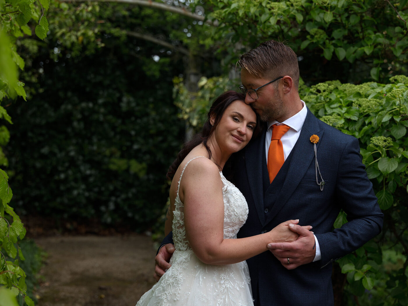 A Bride and Groom are cuddled up together after their wedding ceremony at Carr Bank