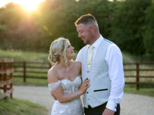 Goldne hour light bathes a bride and groom cuddling. The Barnsdale Rutland wedding